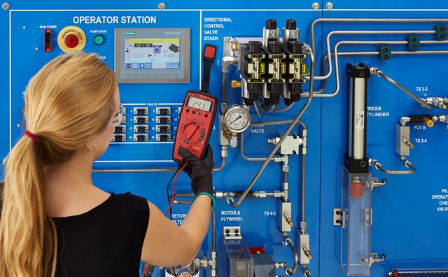 Woman Learning Basic Hydraulics on Amatrol's 950-HTB1 Basic Hydraulic Troubleshooting Learning System